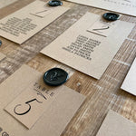 black and brown table plan cards with wax seal