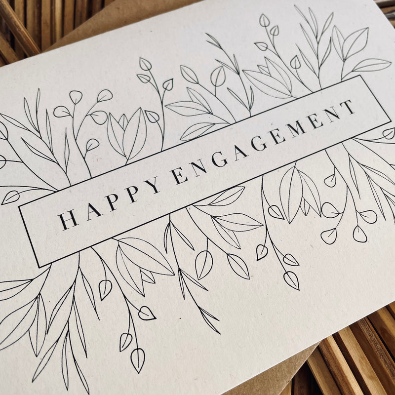 happy engagement card in black foil text on recycled card with a brown envelope