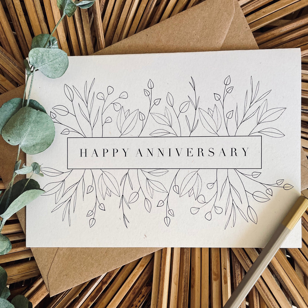 happy anniversary card with floral design in black foil text on recycled card with a brown envelope