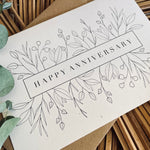 happy anniversary card with floral design in black foil text on recycled card with a brown envelope