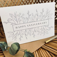 happy anniversary card with floral design in black foil text on recycled card with a brown envelope