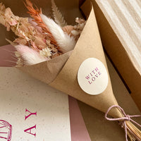 pink and white dried flower bouquet and card