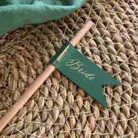 brown paper straw with forest green card, personalised with gold foil names for woodland wedding theme, outdoor dinner party.