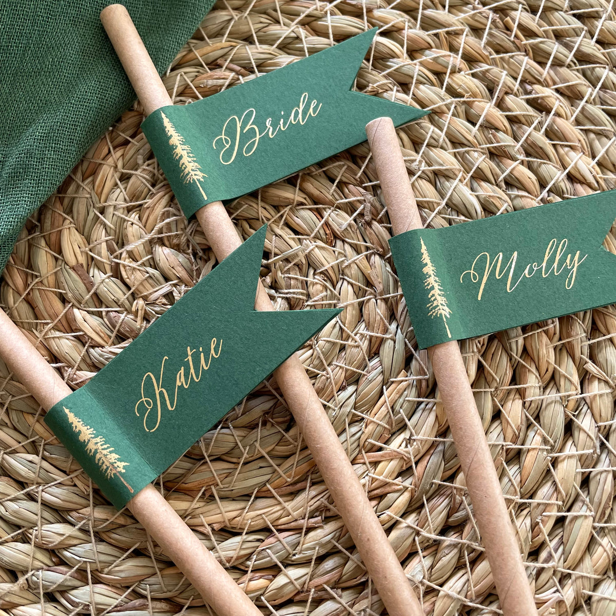 brown paper straw with forest green card, personalised with gold foil names for woodland wedding theme, outdoor dinner party.