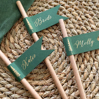 brown paper straw with forest green card, personalised with gold foil names for woodland wedding theme, outdoor dinner party.