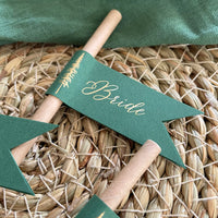 brown paper straw with forest green card, personalised with gold foil names for woodland wedding theme, outdoor dinner party.