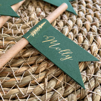 brown paper straw with forest green card, personalised with gold foil names for woodland wedding theme, outdoor dinner party.