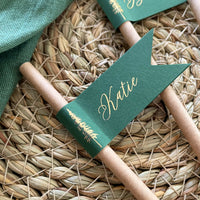 brown paper straw with forest green card, personalised with gold foil names for woodland wedding theme, outdoor dinner party.