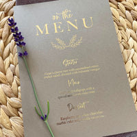 brown menu card with gold foil text personalised with wedding breakfast for rustic place seettings