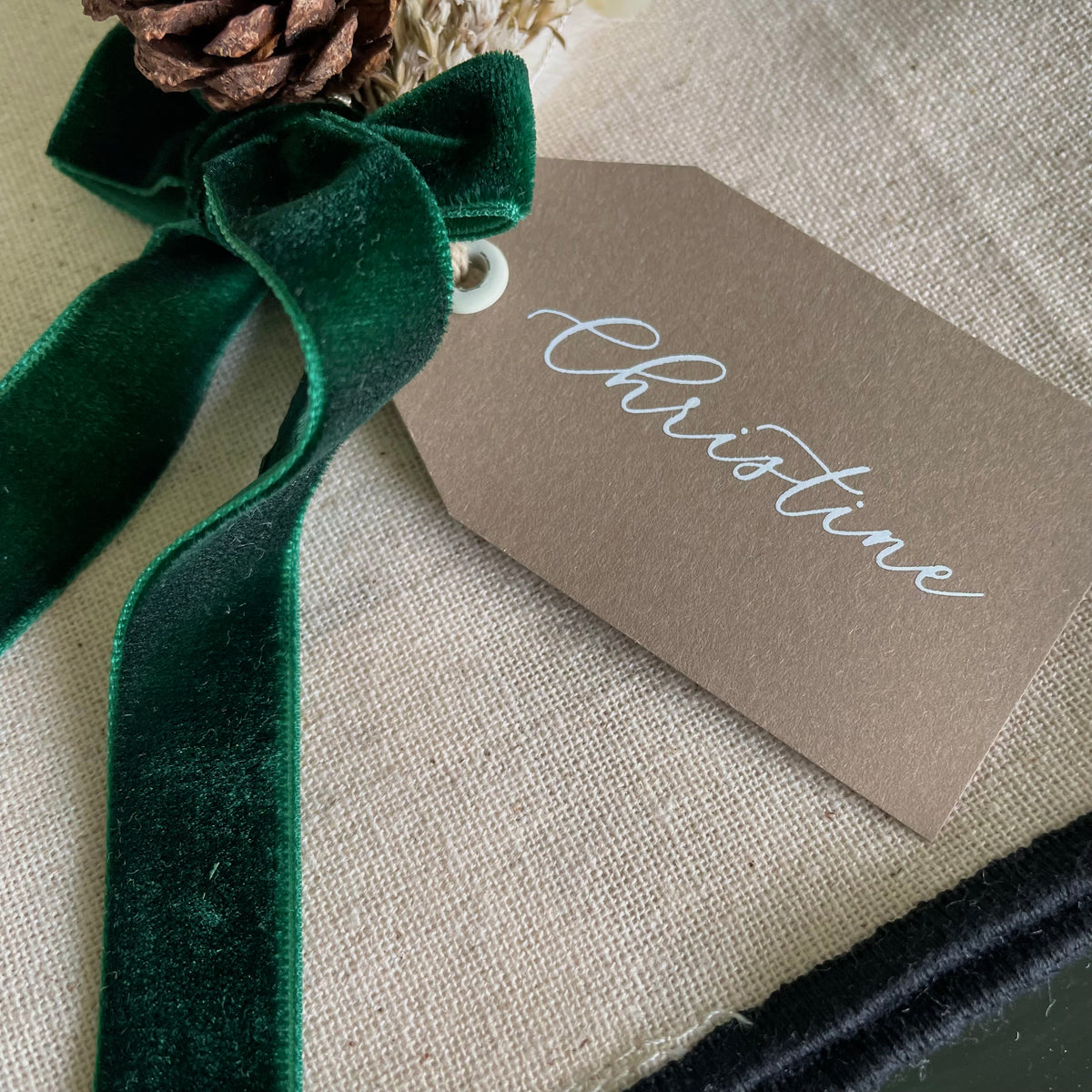 brown, whote and green christmas name tag with dried flower mini bouquet