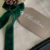 brown, whote and green christmas name tag with dried flower mini bouquet