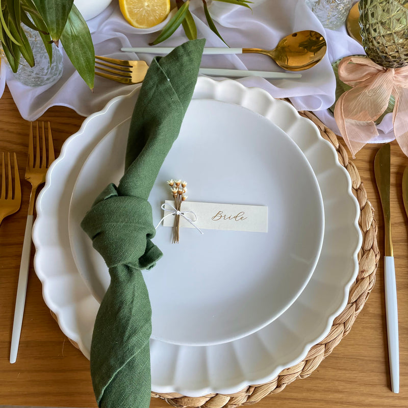 cream and gold foil name tags with white dried flowers