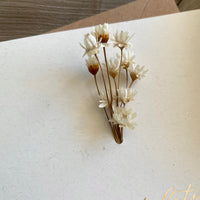 Small bouquet of dried flowers on ivory engagement card