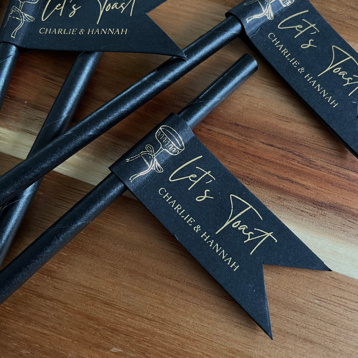black and gold foil drink straws personalised with couples names for engagement or wedding day