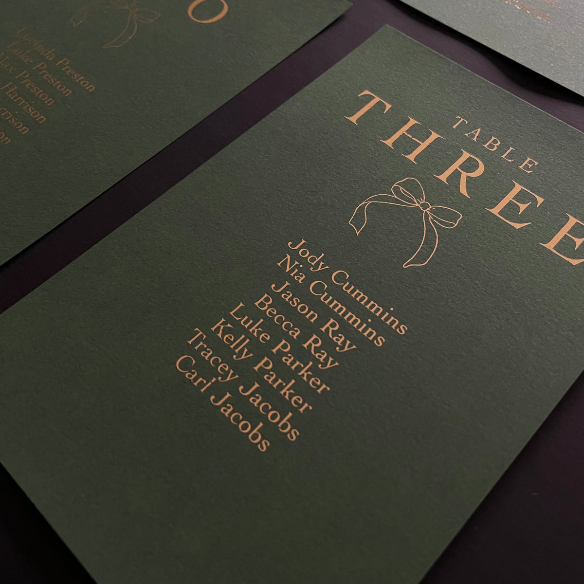 green and gold foil christmas wedding seating plan cards