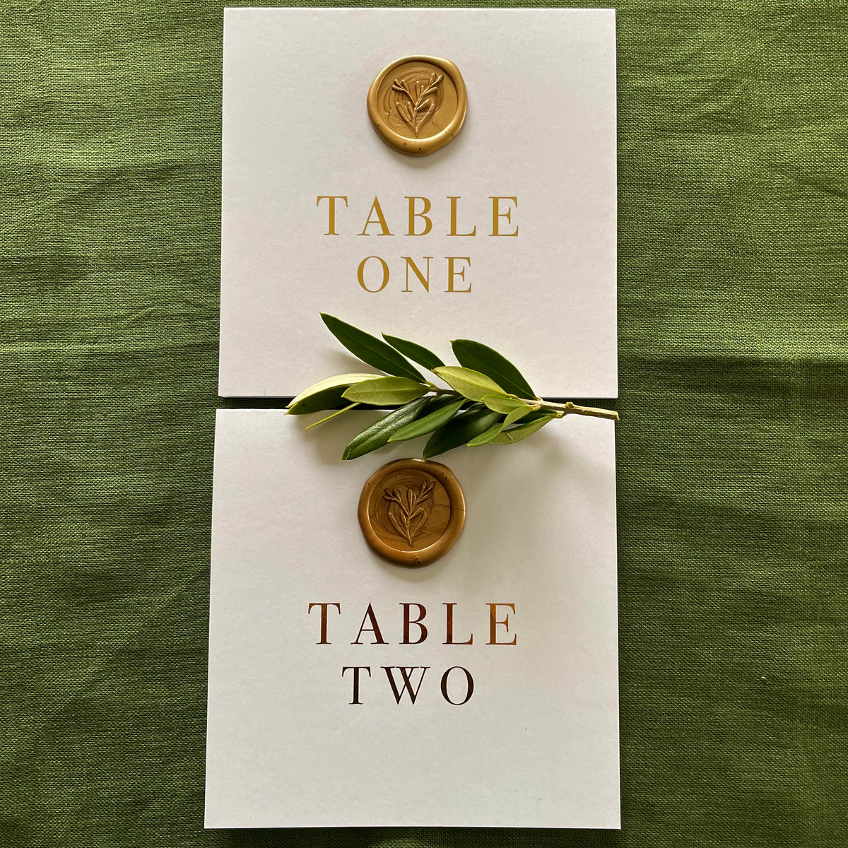 botanical gold wax seal on folded table numbers for modern wedding