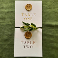 botanical gold wax seal on folded table numbers for modern wedding