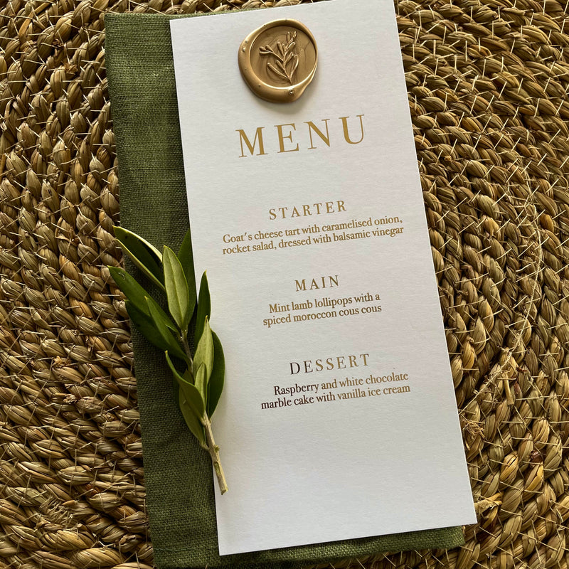 white and gold wedding dinner menu with gold wax seal