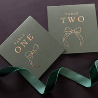dark green and gold tented table number cards for wedding reception