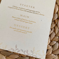 gold foil and ivory card wedding menu with leaf design