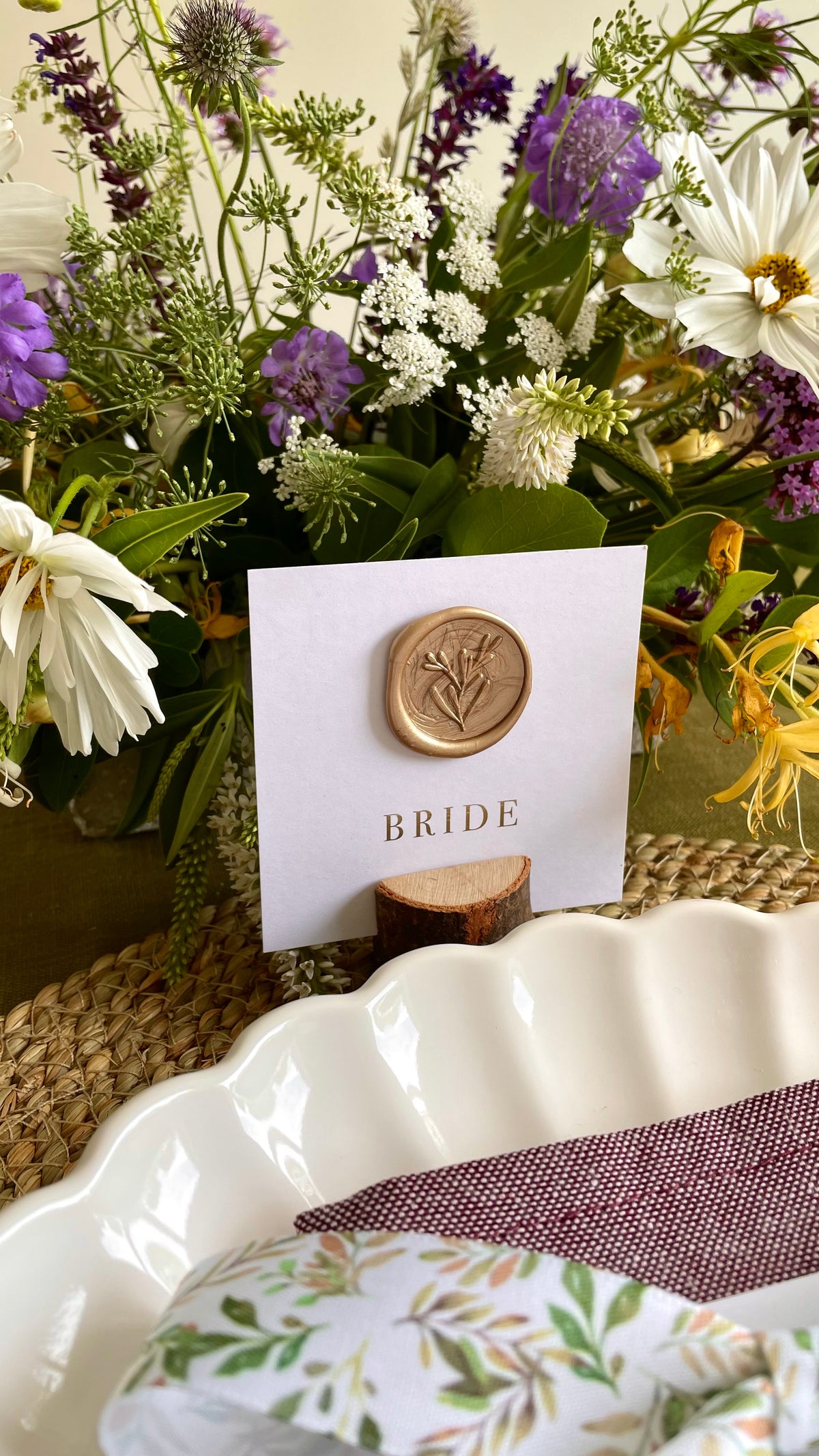 square white name card with wax seal and gold foil names
