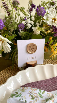 square white name card with wax seal and gold foil names
