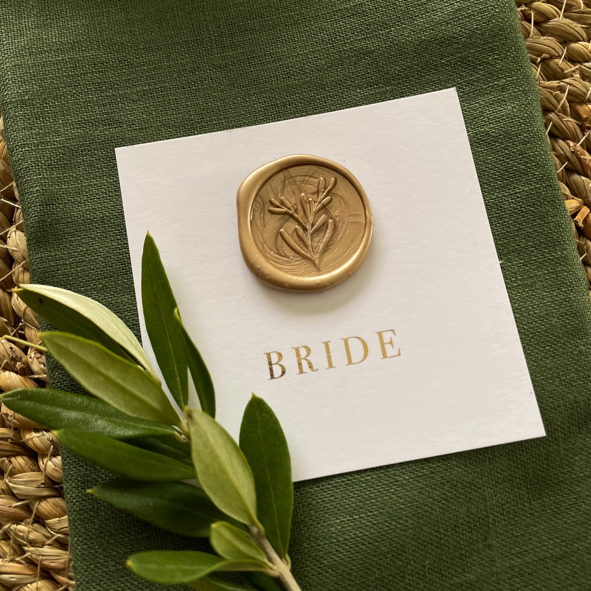flat square name card with gold wax seal and gold foil guest name for place settings on table
