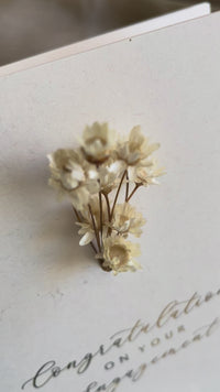 dried flower engagement card for happy couple in cream and gold foil text