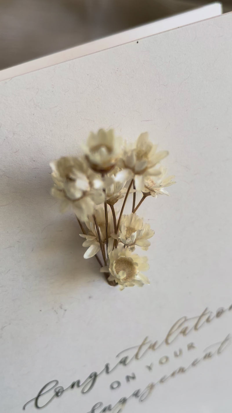 dried flower engagement card for happy couple in cream and gold foil text