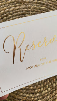 reserved ceremony chair signs in gold foil and white card