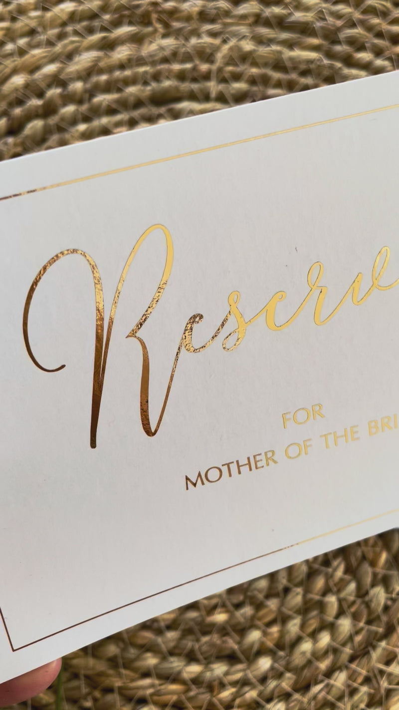 reserved ceremony chair signs in gold foil and white card