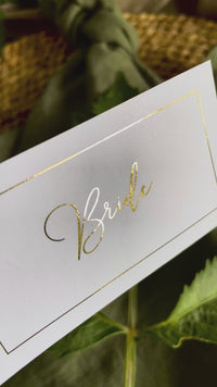 flat white and gold place cards for elegant wedding table