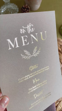 menu card in gold foil on brown card for rustic wedding reception