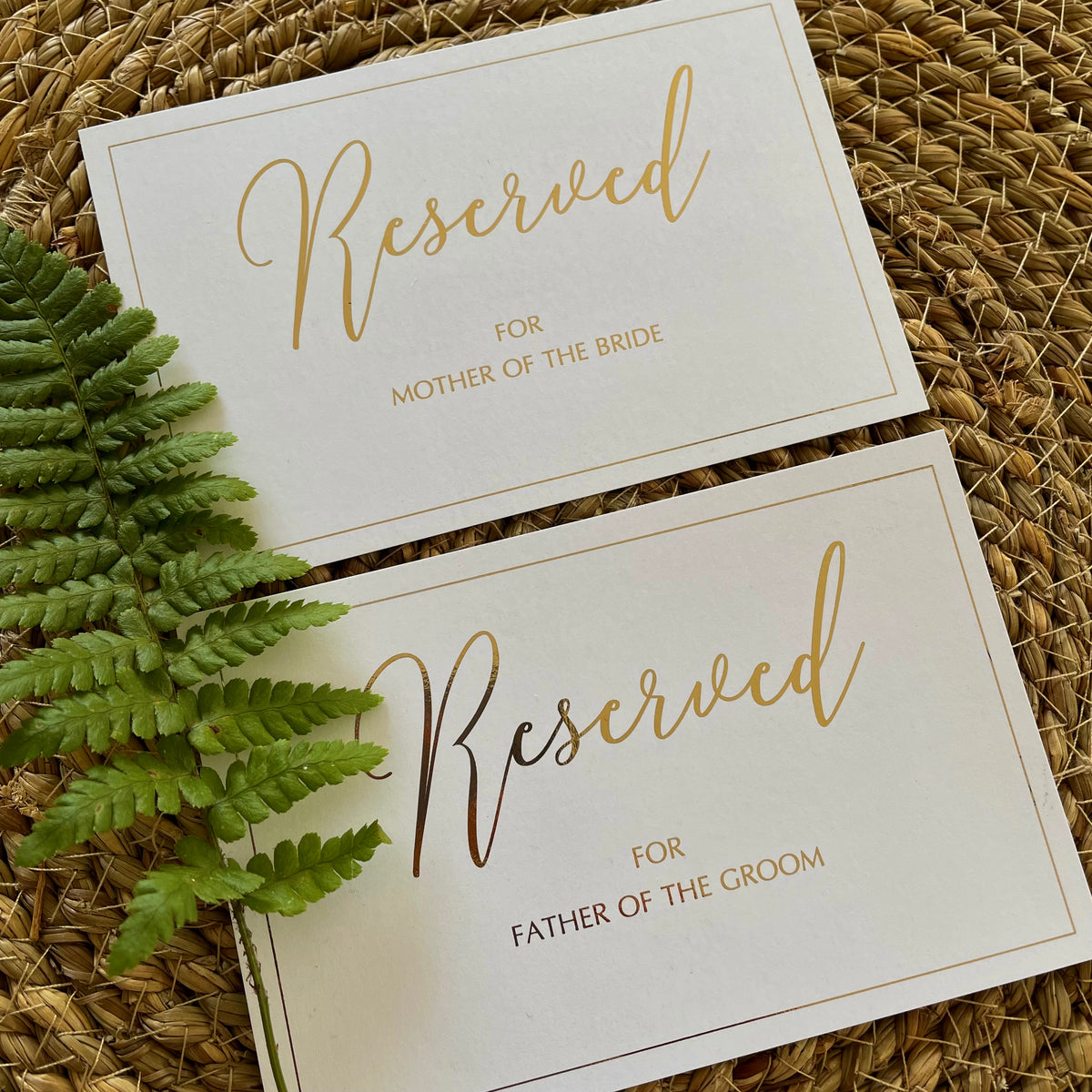 gold foil and white reserved cards personalised with guests names for elegant wedding ceremony