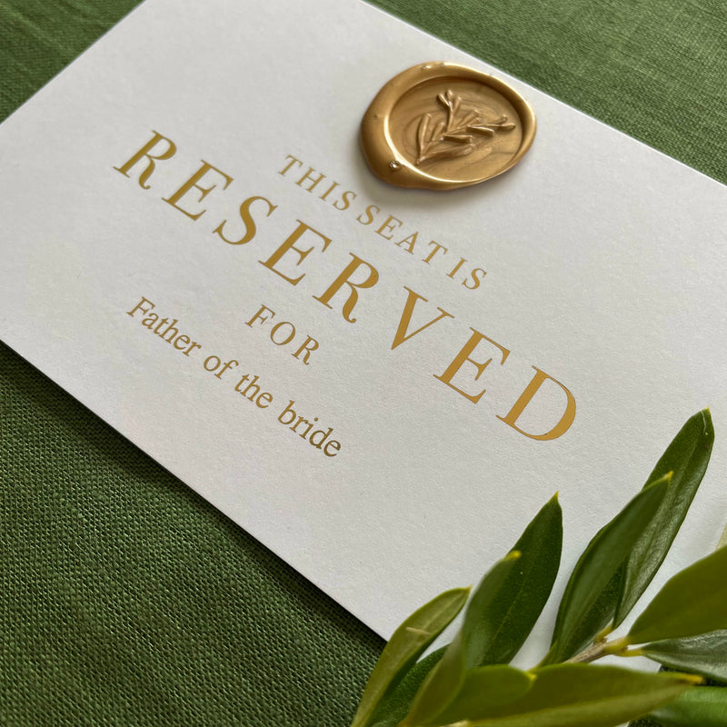 flat white and gold reserved seating card for guest ceremony seating