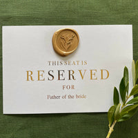 wax seal reserved cards for ceremony chairs on white card and gold foil