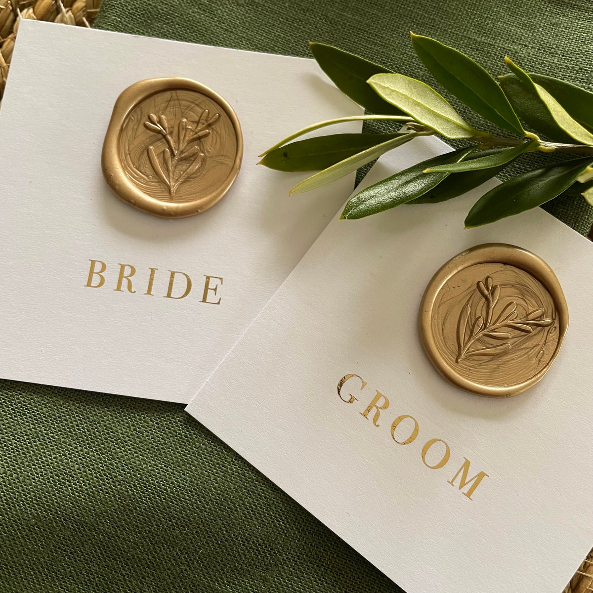 flat name cards for wedding on white card with gold foil and a gold wax seal