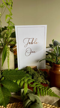 white table number sign for elegant wedding reception in gold foil text with gold foil border