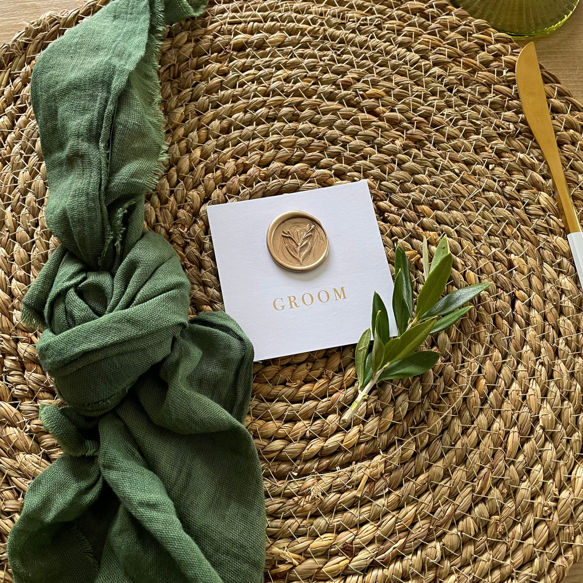 white square place setting cards with gold foil and gold wax seal for guests