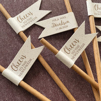 Decorative brown paper straws with recycled flag shape with bronze foil text cheers to the newlyweds on the front and customisable text on the back with couples married name and date. for wedding drinks on arrival