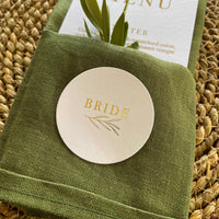 gold foil and white circular name tags for place settings wedding or engagement party