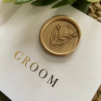 gold wax seal name setting card on what square flat card with gold foil names or wedding reception tables