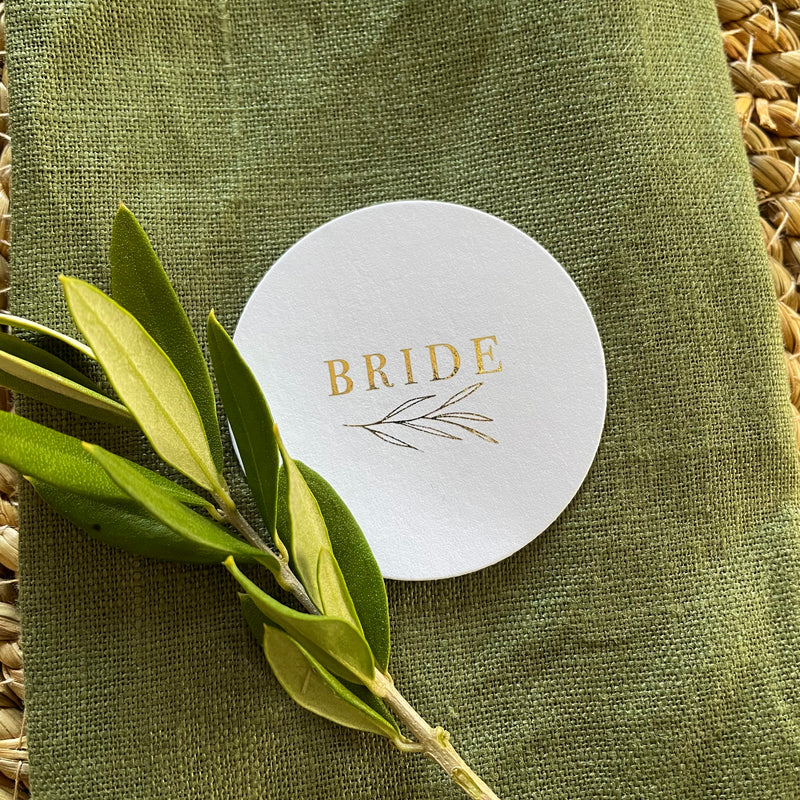 round gold foil and white name tags for wedding tables