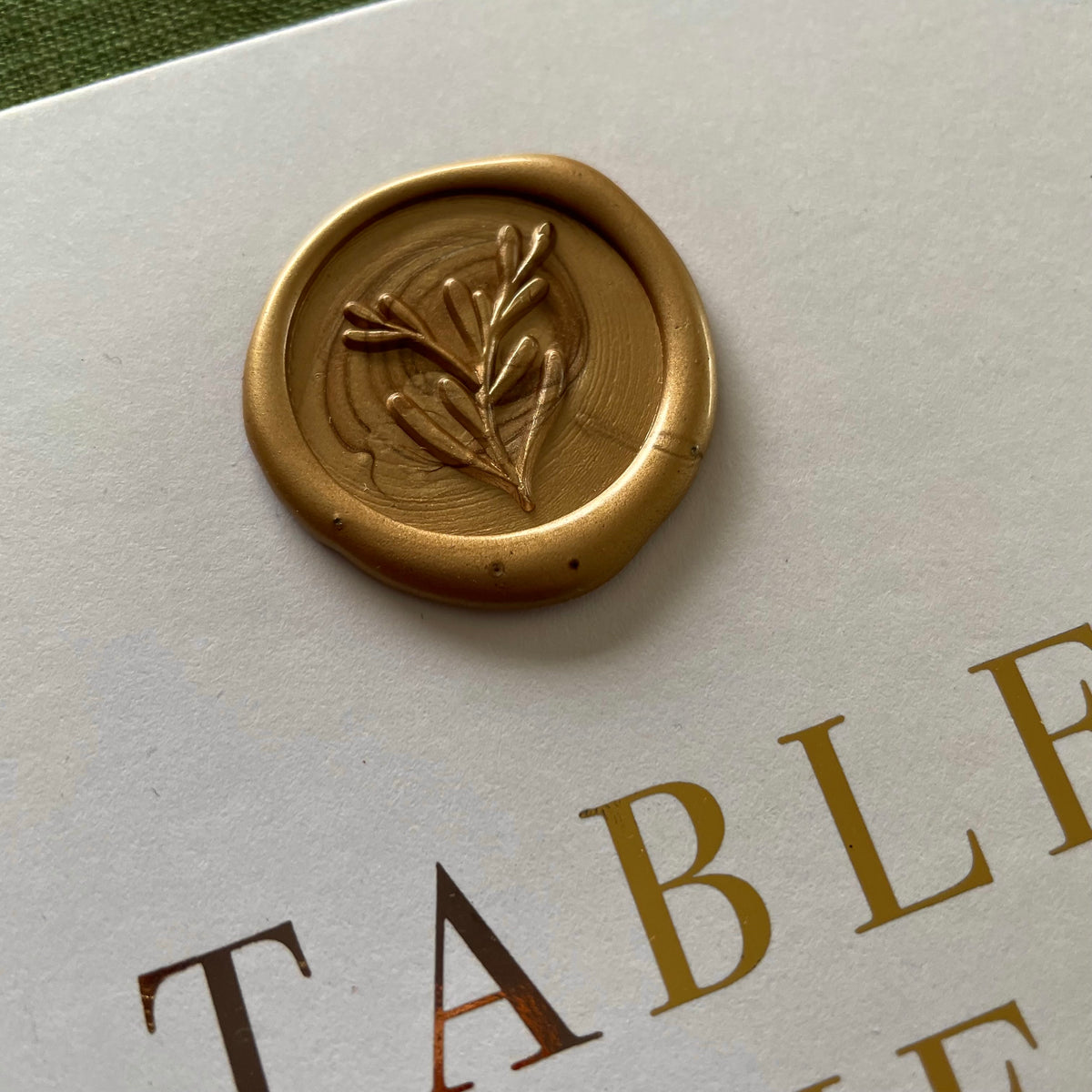 Folded gold foil table numbers with gold wax seal for wedding