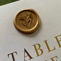 Folded gold foil table numbers with gold wax seal for wedding