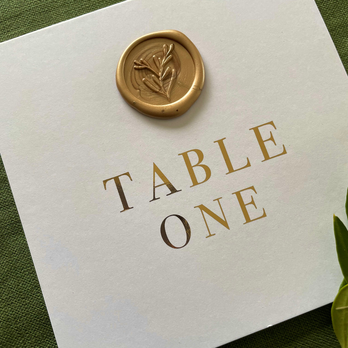 white and gold foil wedding table numbers with gold wax seal 