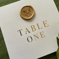 white and gold foil wedding table numbers with gold wax seal 