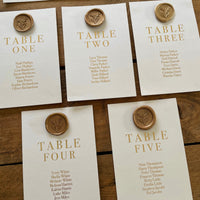 white and gold table plan cards for rustic wedding with wax seals